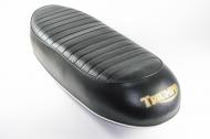 This is a seat to fit the T100/120 1969-70. Has lugs for handle. Made in India
