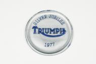 This is the silver jubilee badge for a top cover of a gas tank on a triumph motorcycle. 